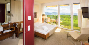 A bed in a room with mountain views, perfect for those who want to make new friends during their stay at AVIVA.