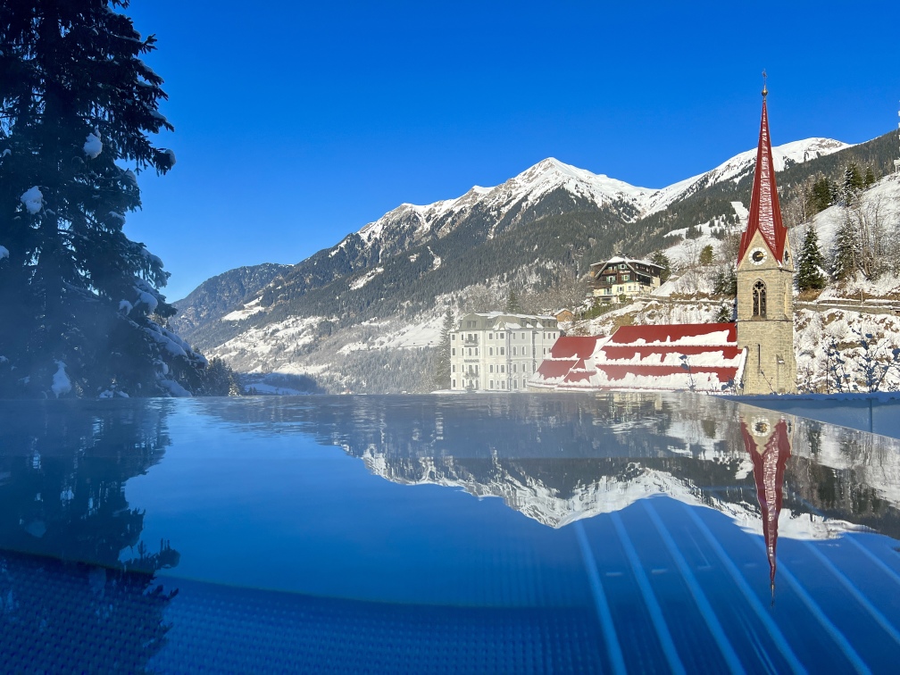 A swimming pool with a church in the background.