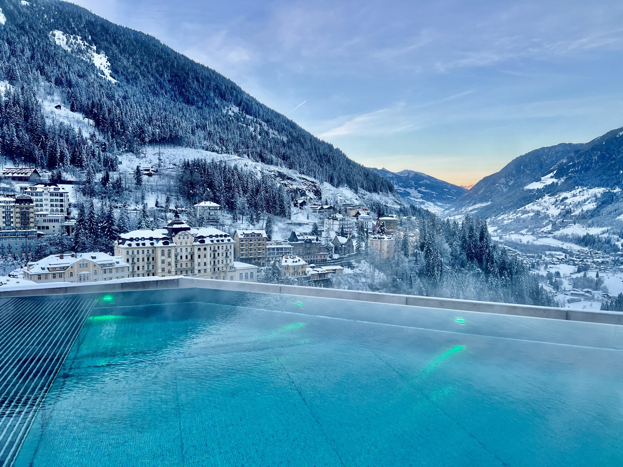 A swimming pool in the middle of a snow covered mountain.